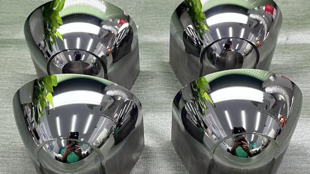 Four mirror-polished automotive optical mold inserts prepared for reflector and lighting component molding.