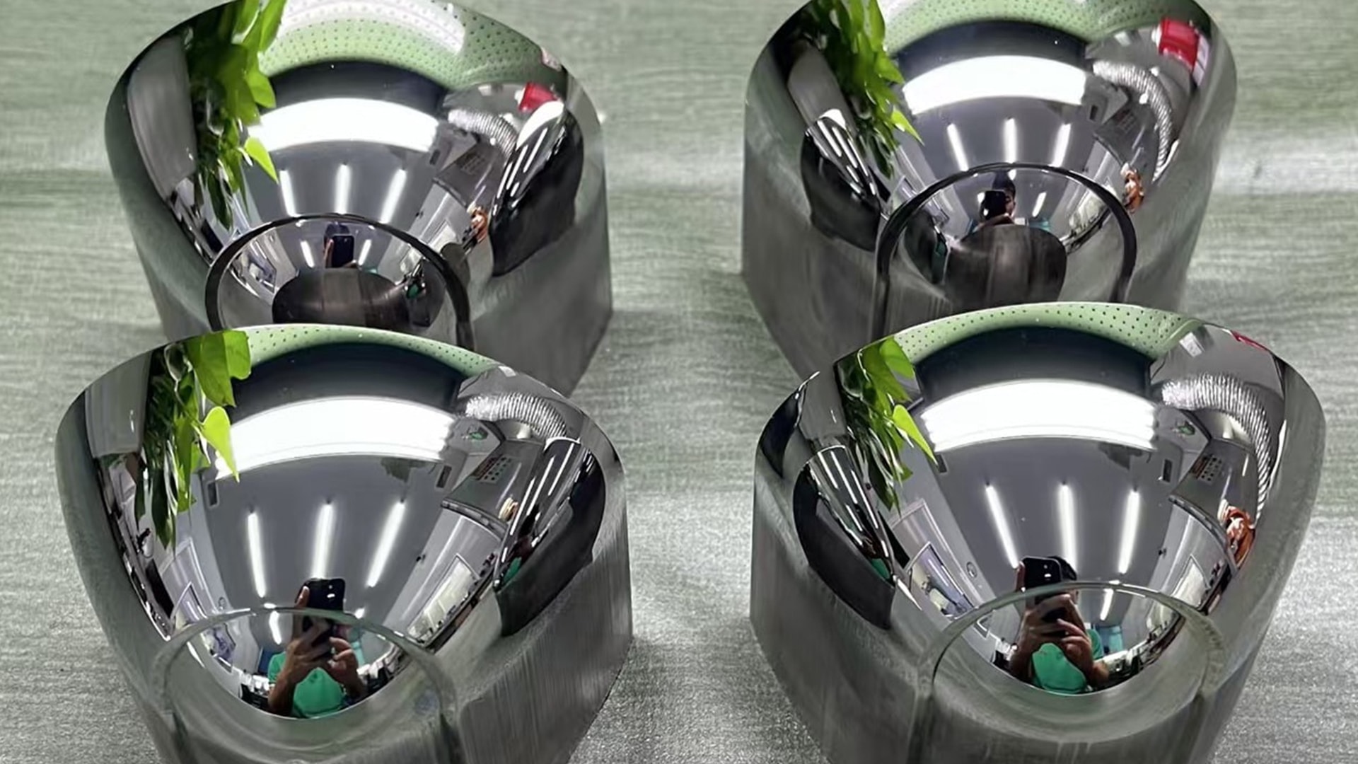 Four mirror-polished automotive optical mold inserts prepared for reflector and lighting component molding.