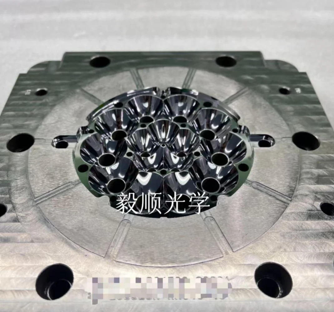 Automotive optical mold detail showing multiple precision optical feature positions