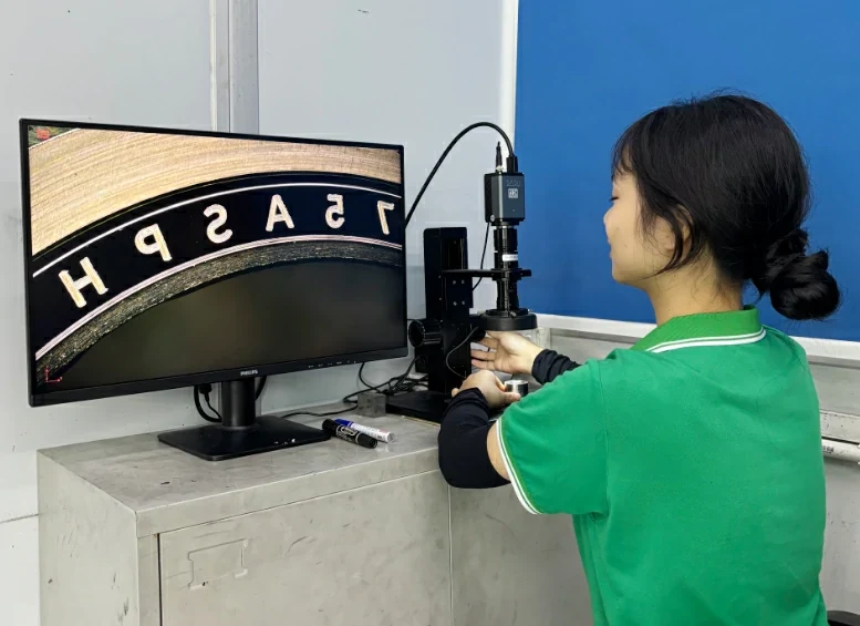 Operator using a microscope-based inspection station at YISHUN