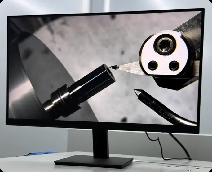 Precision machining monitor showing small optical component machining